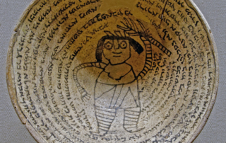 Mesopotamian Incantation bowl with an Aramaic inscription around a demon.